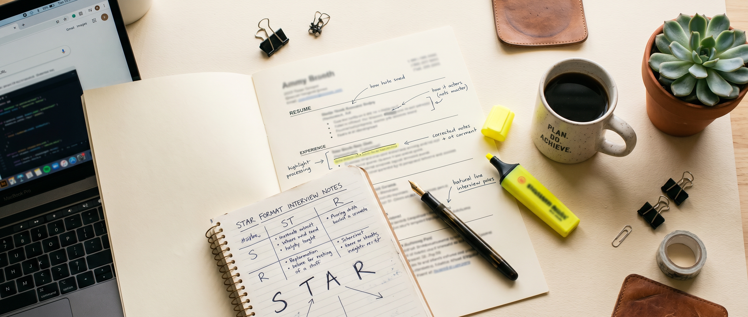 Editorial workspace with resume, notebook, and coffee